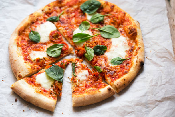 istock Pizza with tomato sauce, mozzarella and spinach 1457061724