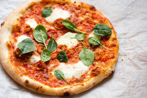 istock Pizza with tomato sauce, mozzarella and spinach 1457061726