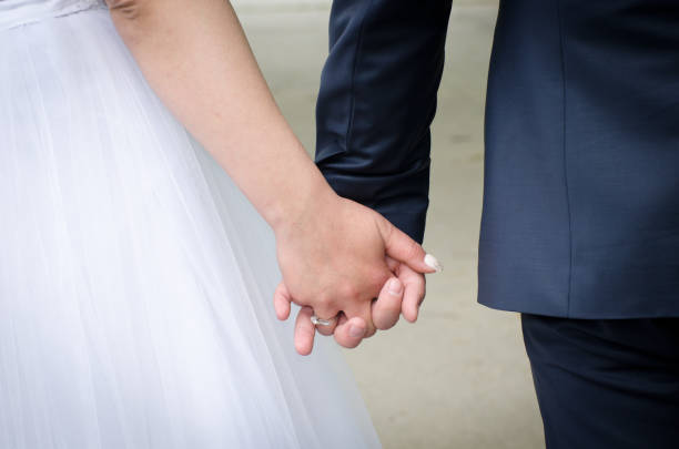 istock bride and groom holding hands at the wedding 1457061790