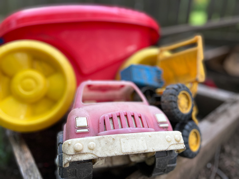 Old dirty toys in sandbox