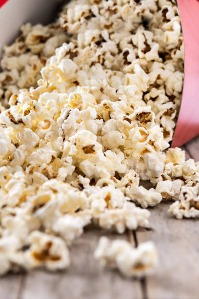 istock Salted popcorn on wooden table 1457063644