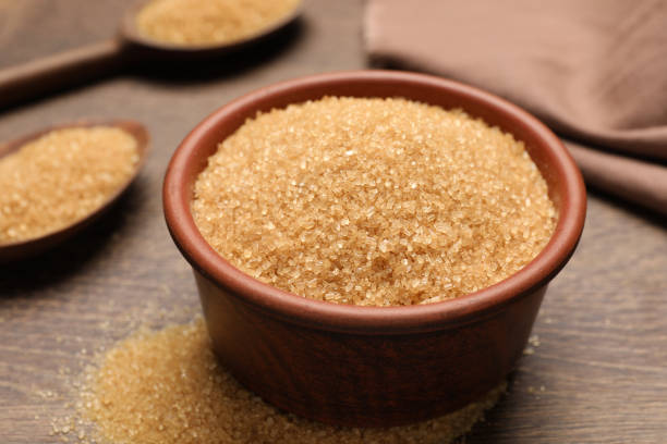 istock Brown sugar on wooden table, closeup view 1457064640