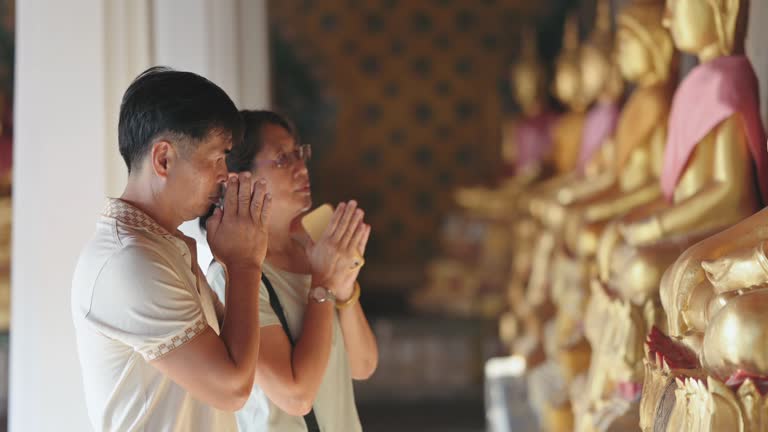 Active thai senior Asian Couple sawasdee at Wat pho temple, landmark bangkok thailand