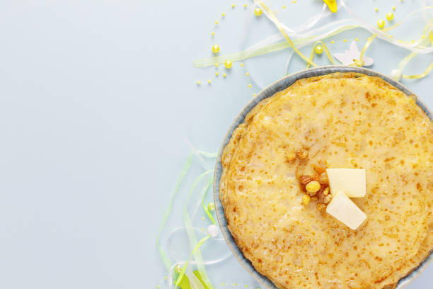 istock Home made fried crepeswith decoration on a blue background 1457066670