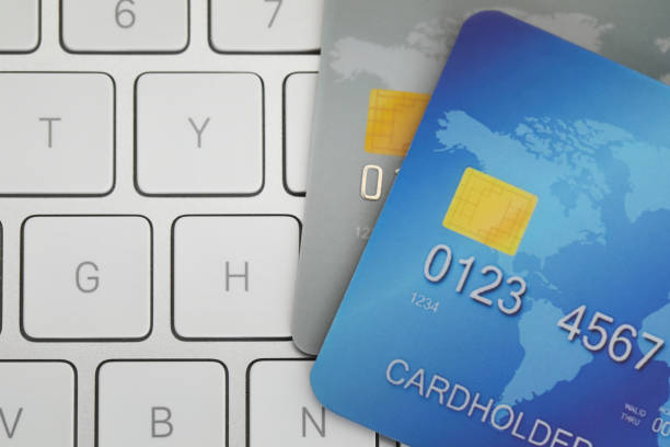 istock Online payment concept. Bank cards on computer keyboard, top view 1457067199