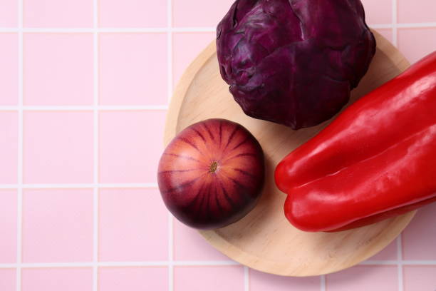 Raw fresh tomato, pepper, red cabbage on wooden plate