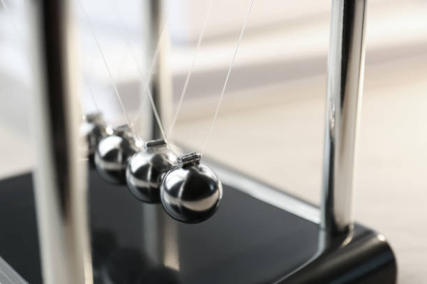 istock Newton's cradle on table, closeup. Physics law of energy conservation 1457068442