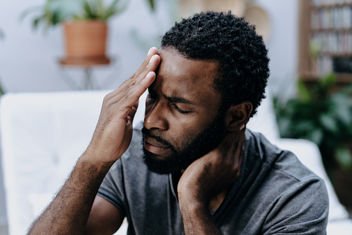 Man with headache and neck pain