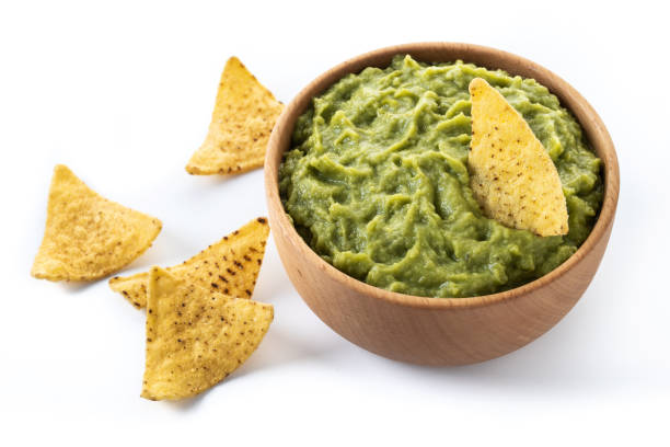 istock Mexican guacamole with nacho chip isolated on white background 1457070170