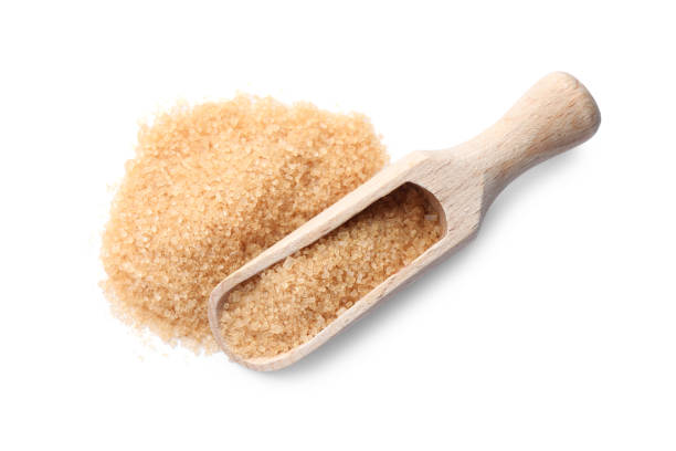 istock Wooden scoop and brown sugar on white background, top view 1457070568