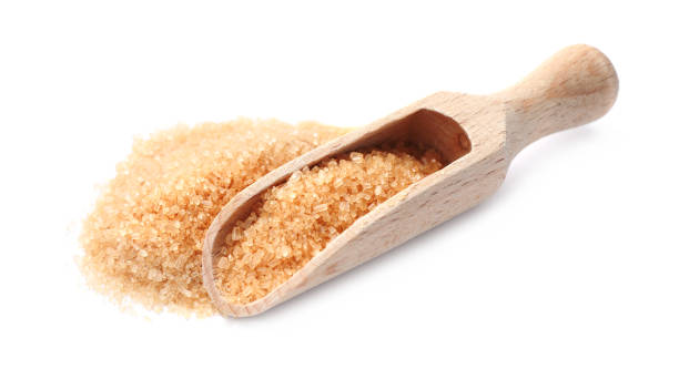 istock Wooden scoop and brown sugar on white background 1457070686
