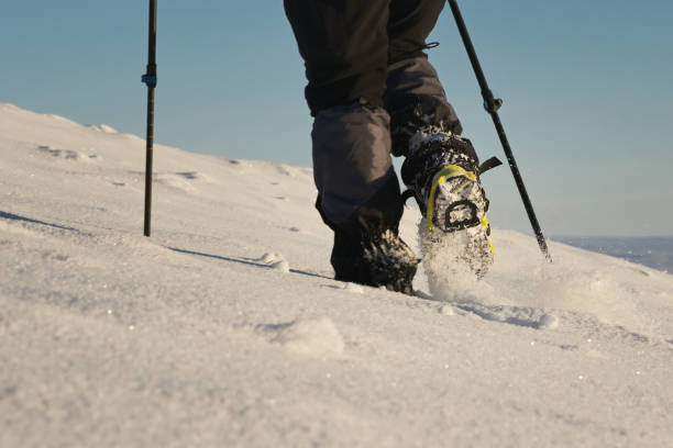 istock Man Walking On Snow With Shoe Spikes In Winter 1457070804