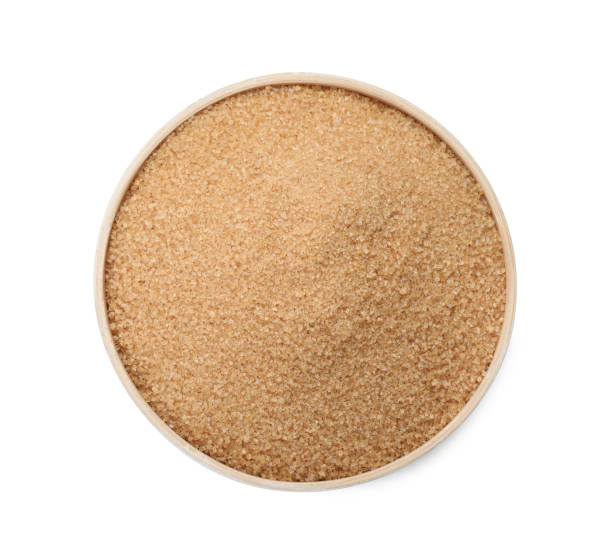 istock Brown sugar in bowl isolated on white, top view 1457071420