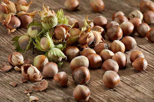 Group of hazelnuts on rustic wood