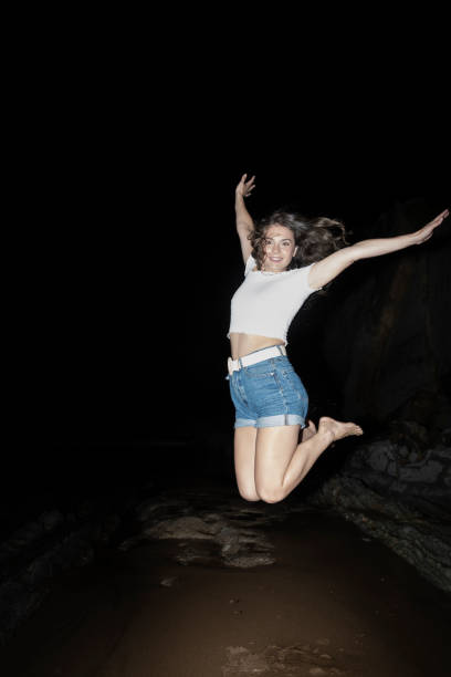 Woman Jumping In The Air On Beach