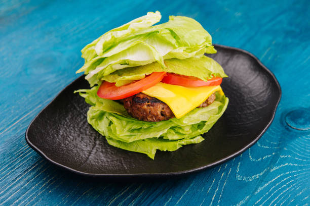 Healthy hamburger wrapped in lettuce stock photo