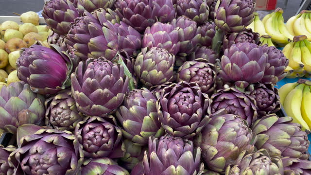Vegetable purple artichokes on display at local market