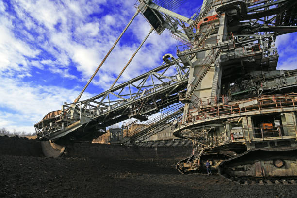 istock Bucket-wheel excavator during excavation at the surface mine. Huge excavator on open pit mine. 1457082188