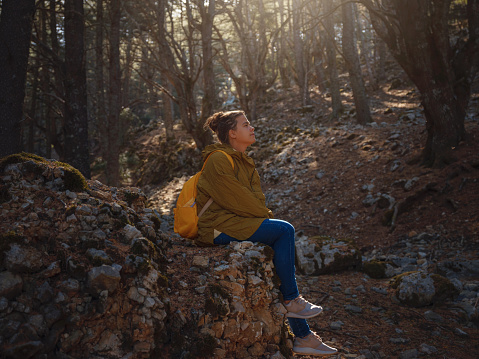 caucasian woman enjoys being in nature, beautiful forest in mountains. embracing fresh air and engaging in outdoor activities. Friluftsliv concept means spending as much time outdoors as possible