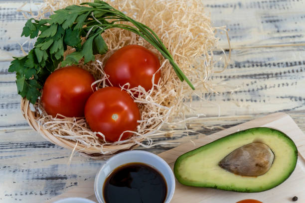 istock Tomatoes, cucumbers and avocado on the table, olive oil and balsamic vinegar, garlic, vegetables, vegetarianism, healthy eating 1457084485