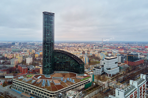 Drone flight over Wroclaw cityscape with Sky Tower skyscraper. Aerial view of modern european city in Poland