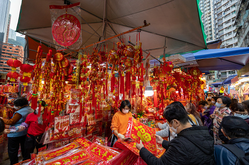Hong Kong - January 17, 2023 : People select new year decorations at street market ahead of Chinese New Year in Hong Kong.