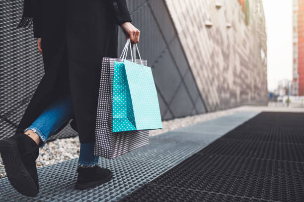istock Young womans in front of a shopping centre 1457089405