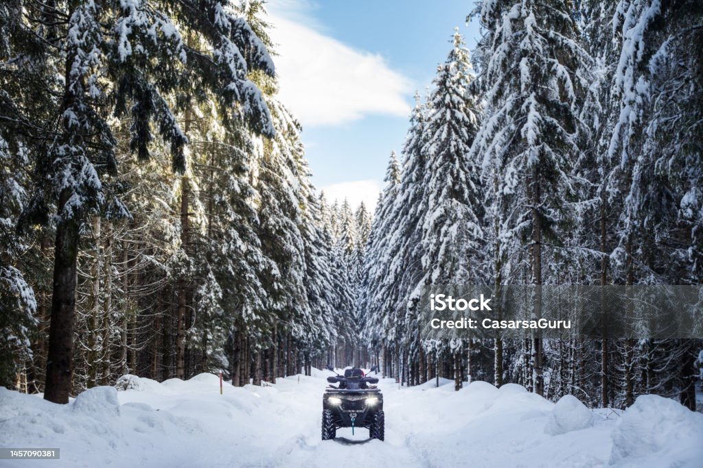 Reaching the remote location in the woods with an ATV Off-Road Vehicle Stock Photo