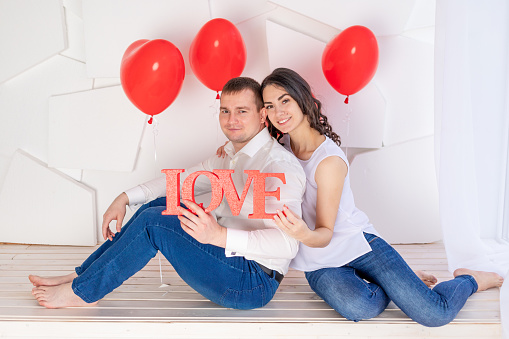 valentine's day, a couple in love holding a big love sign