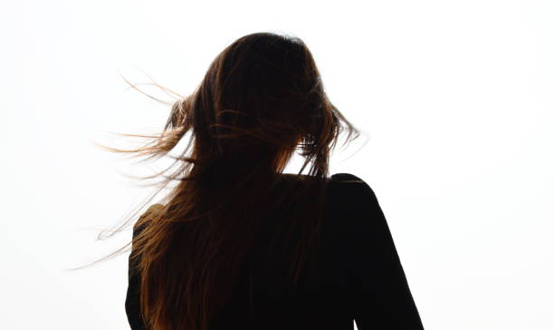 istock silhouette back woman wind flowing from wind blow in white sky background 1457096951