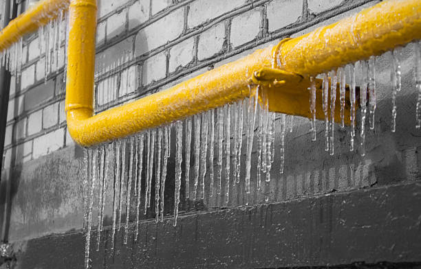 a yellow icy pipe with gas on the background of a gray wall. - pipe imagens e fotografias de stock