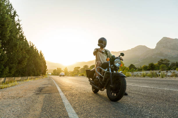 istock Young man with helmet riding a motorbike 1457099704