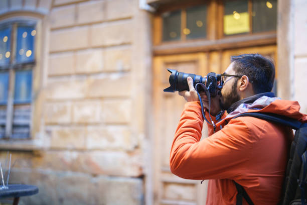 istock Traveller taking photograph in town 1457100527