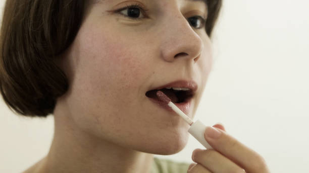 istock Young woman putting on makeup 1457101287