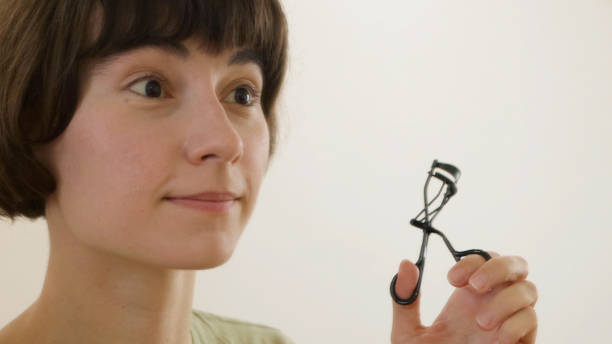 istock Young woman putting on makeup 1457101383
