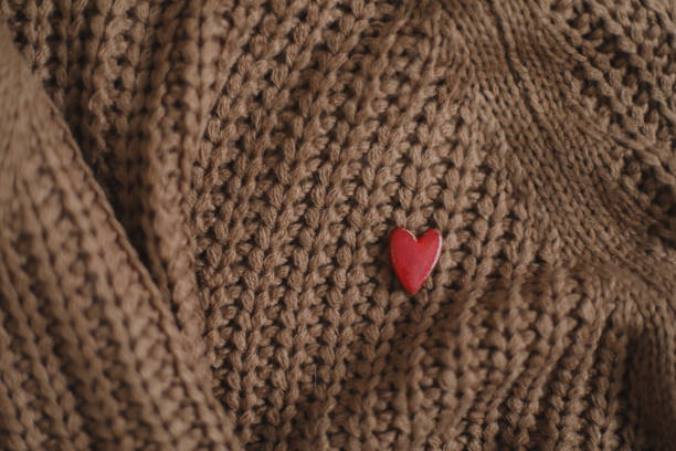 istock Decorative red heart on beige knitted texture background. Valentines day celebration or love concept. 1457101504