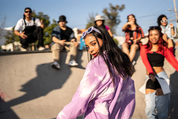 portrait of young woman dancing at street party - street style imagens e fotografias de stock