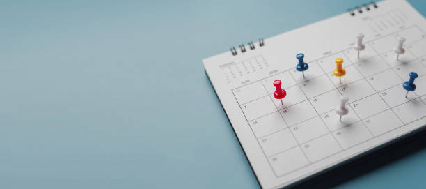 istock Embroidered red pins on a calendar event Planner calendar,clock to set timetable organize schedule,planning for business meeting or travel planning concept. 1457103571