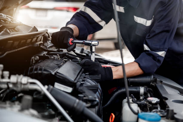 istock Car care maintenance and servicing, Close-up hand technician auto mechanic using the wrench to repairing change spare part car engine problem and insurance service support. 1457103682