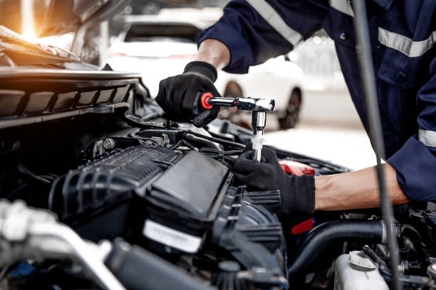 istock Car care maintenance and servicing, Close-up hand technician auto mechanic using the wrench to repairing change spare part car engine problem and insurance service support. 1457103762