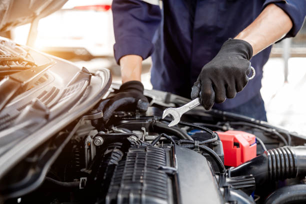 istock Car care maintenance and servicing, Close-up hand technician auto mechanic using the wrench to repairing change spare part car engine problem and insurance service support. 1457103779
