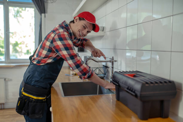 istock Joyful plumbing technician fixing a faucet in a client apartment 1457104333