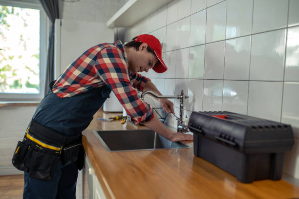 istock Serious young plumber repairing a kitchen tap 1457104339