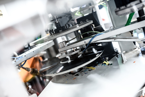 Large format inkjet printer machine working on vinyl paper in workplace