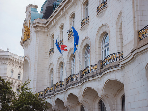 flag of France and the European Union on the facade of an old house. Cityscape views old city of one of Europe's most beautiful town- Vienna. Summer Travel to capital of Austria.