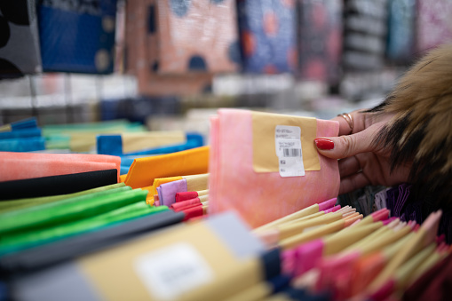 Woman's hand choosing fabric