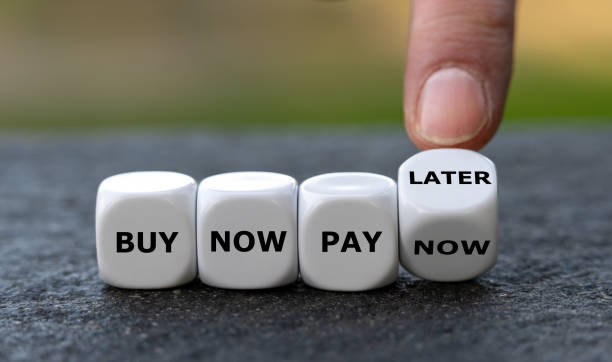 istock Hand turns dice and changes the expression 'buy now pay now' to 'buy now pay later'. 1457110345