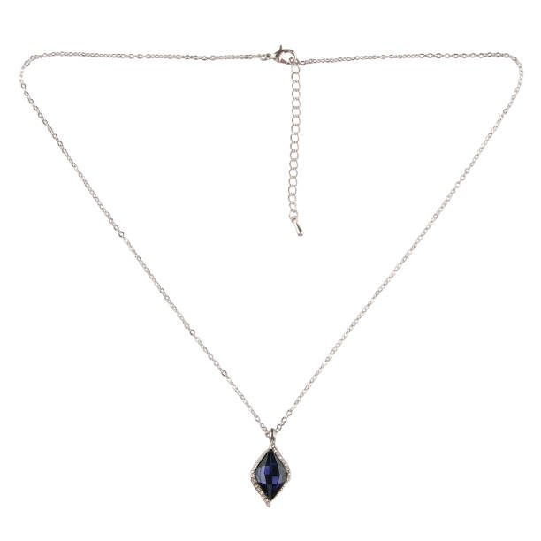 istock Silver pendant with a blue diamond sapphire on a thin chain on a white background 1457110517