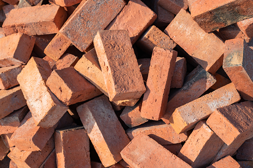 pile of red bricks prepare for the construction of various buildings.