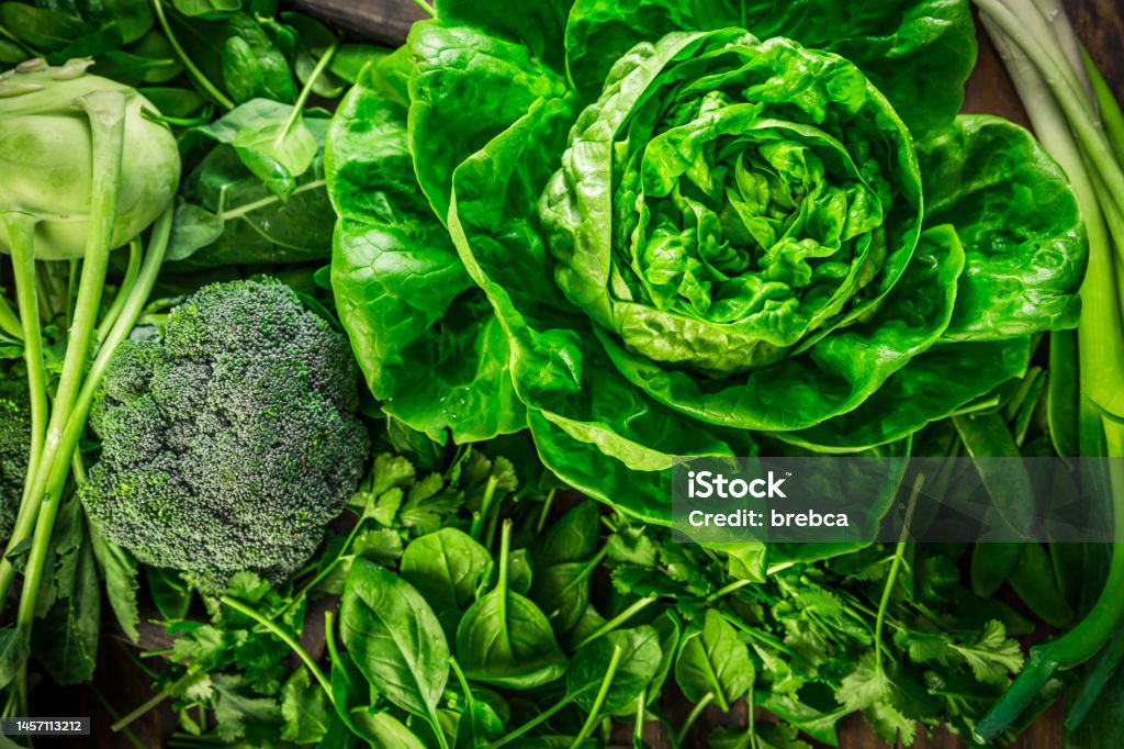 Green organic vegetables and dark leafy food background as a healthy eating concept Green organic vegetables and dark leafy food background as a healthy eating concept of fresh garden produce Vegetable Stock Photo